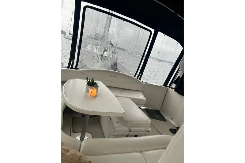 Slide: The Image of Interior of 2001 Sea Ray 380 Sundancer yacht with table and seating, overlooking water. - 11
