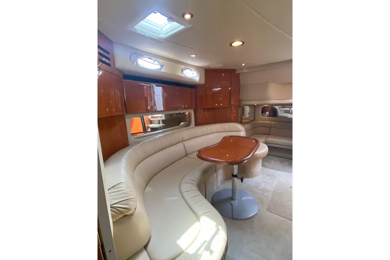 Slide: The Image of Luxurious interior of 2001 Sea Ray 380 Sundancer yacht with plush seating and elegant wood finishes. - 14