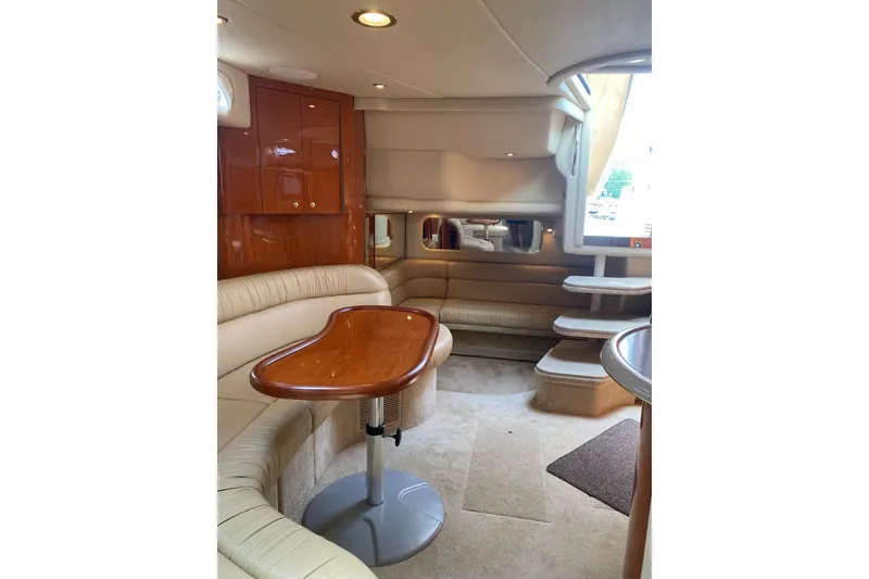 Slide: The Image of Luxurious interior of 2001 Sea Ray 380 Sundancer yacht with elegant seating and wooden table. - 15