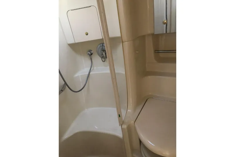 Slide: The Image of Bathroom interior of 2001 Sea Ray 380 Sundancer yacht, featuring shower and toilet. - 18