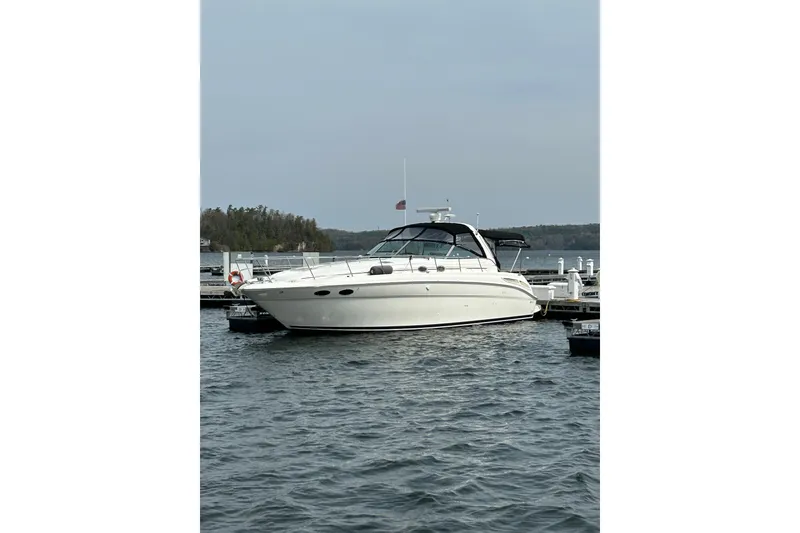 Slide: The Image of 2001 Sea Ray 380 Sundancer yacht docked on a calm lake. - 2