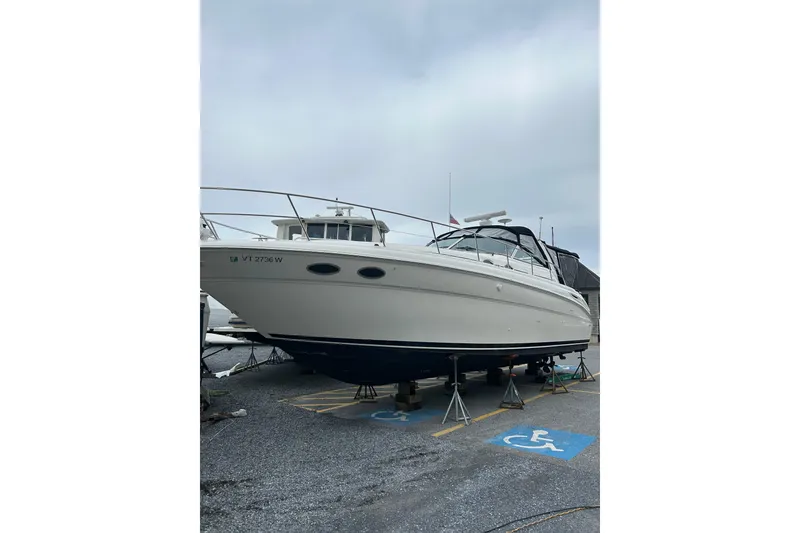 Slide: The Image of 2001 Sea Ray 380 Sundancer boat on stands in a parking lot. - 28