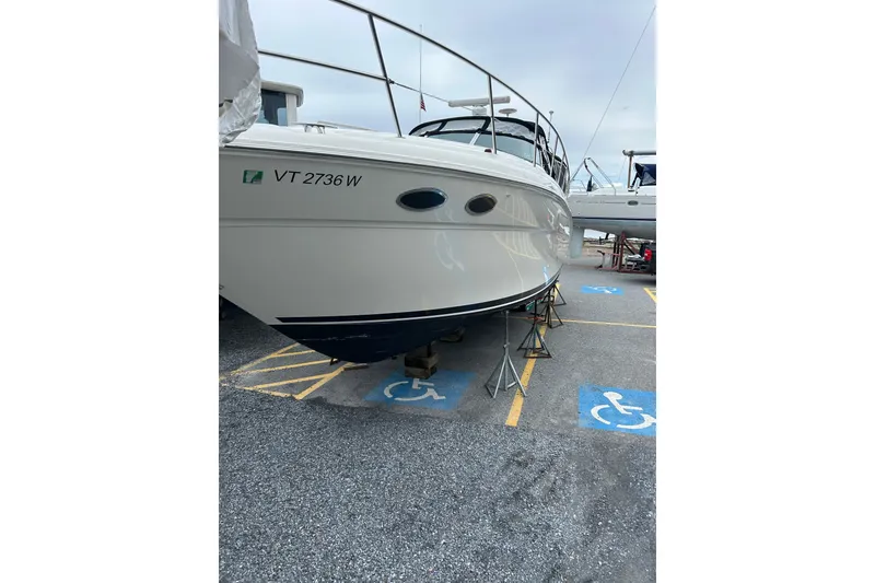 Slide: The Image of 2001 Sea Ray 380 Sundancer boat on stands in a parking lot. - 4