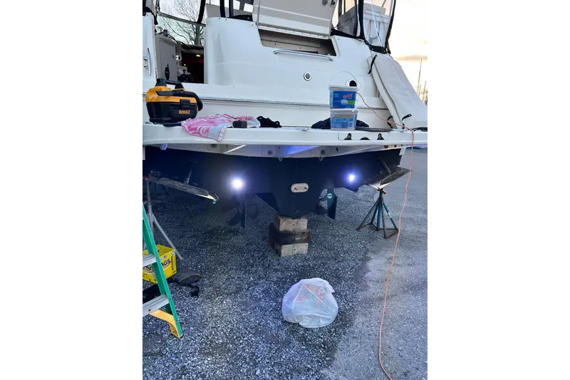 Slide: The Image of 2001 Sea Ray 380 Sundancer undergoing maintenance with tools and lights visible. - 7