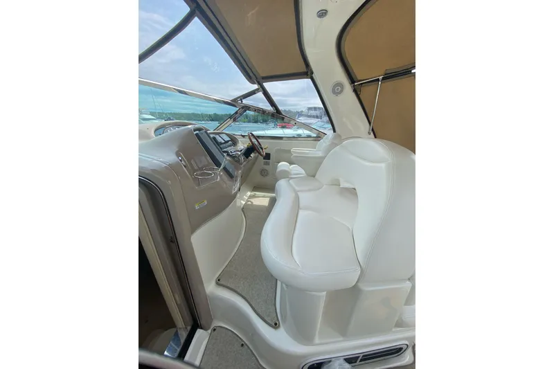 Slide: The Image of 2001 Sea Ray 380 Sundancer helm with white seating and modern controls. - 8