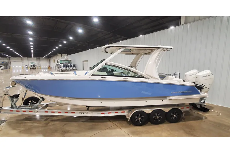 The Image of 2023 Chaparral 300 OSX boat on trailer in indoor showroom. - 0