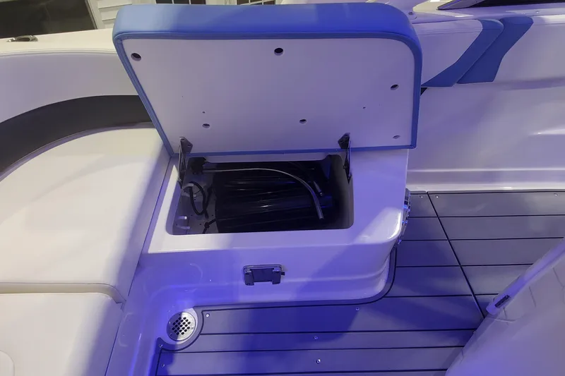 Slide: The Image of Open storage compartment on 2023 Chaparral 300 OSX boat, featuring sleek interior design. - 10