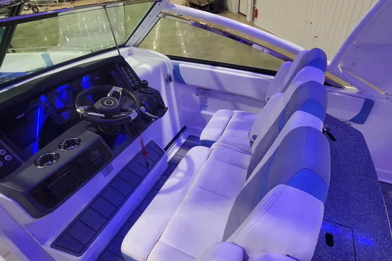 Slide: The Image of 2023 Chaparral 300 OSX boat interior with modern helm and seating. - 19