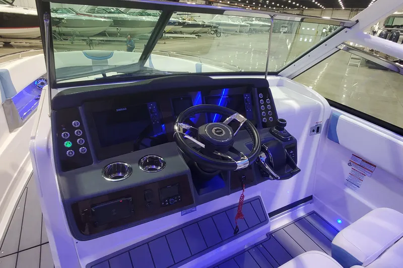 Slide: The Image of 2023 Chaparral 300 OSX boat cockpit with modern steering and control panel. - 20