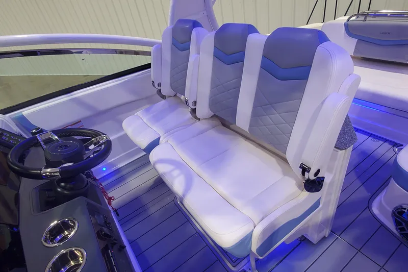 Slide: The Image of 2023 Chaparral 300 OSX boat interior with plush seating and modern steering console. - 22