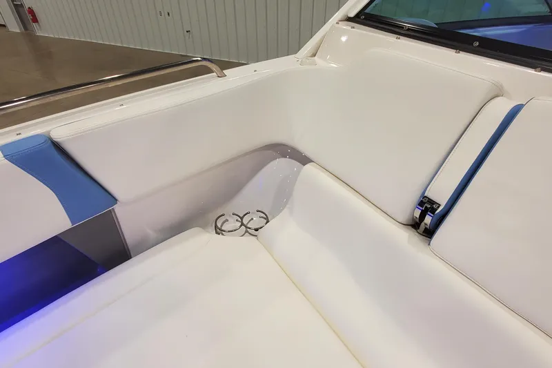 Slide: The Image of 2023 Chaparral 300 OSX boat interior with white and blue seating and cup holders. - 27