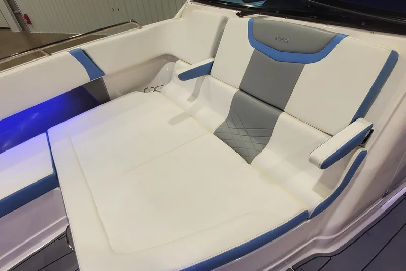 Slide: The Image of 2023 Chaparral 300 OSX boat interior with white and blue cushioned seating. - 28