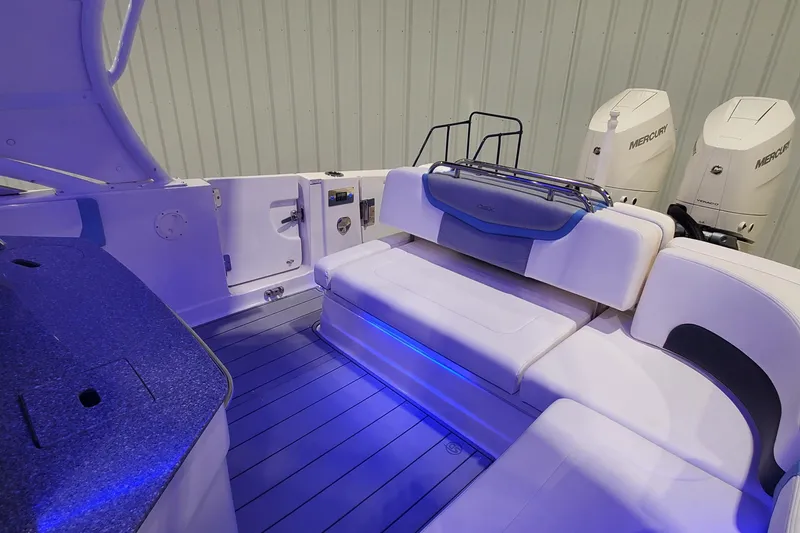 Slide: The Image of 2023 Chaparral 300 OSX boat interior with seating and Mercury engines. - 35
