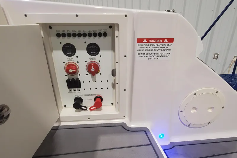 Slide: The Image of Control panel of 2023 Chaparral 300 OSX boat with safety warning label. - 37