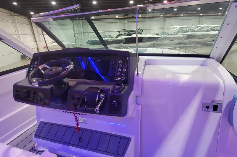Slide: The Image of 2023 Chaparral 300 OSX boat cockpit with modern steering and control panel. - 50