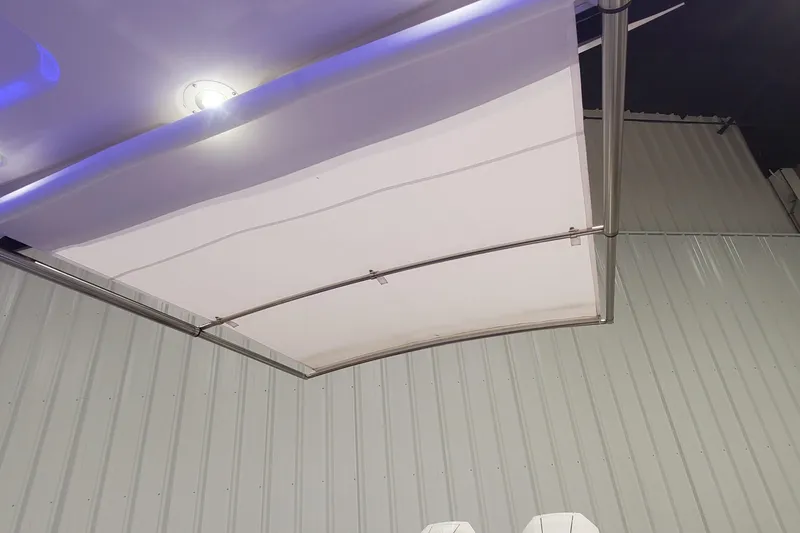 Slide: The Image of 2023 Chaparral 300 OSX boat canopy with sleek metal frame and lighting. - 7