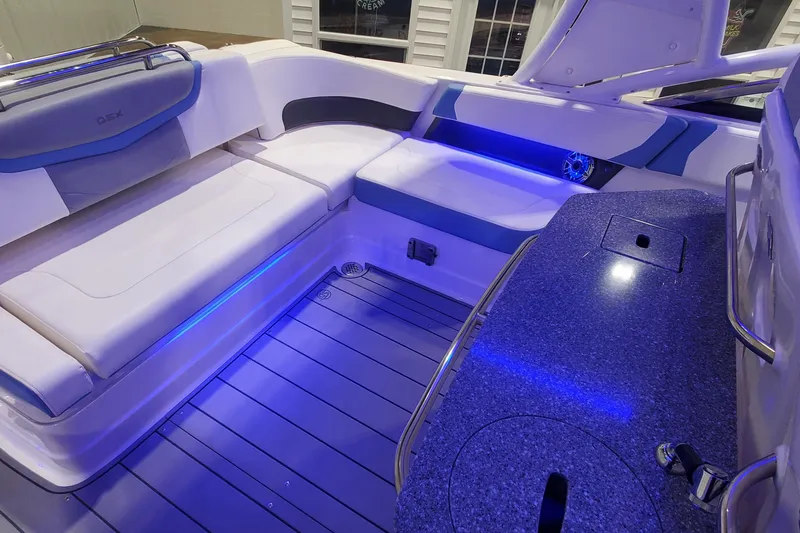 Slide: The Image of 2023 Chaparral 300 OSX boat interior with blue LED lighting and sleek seating. - 9