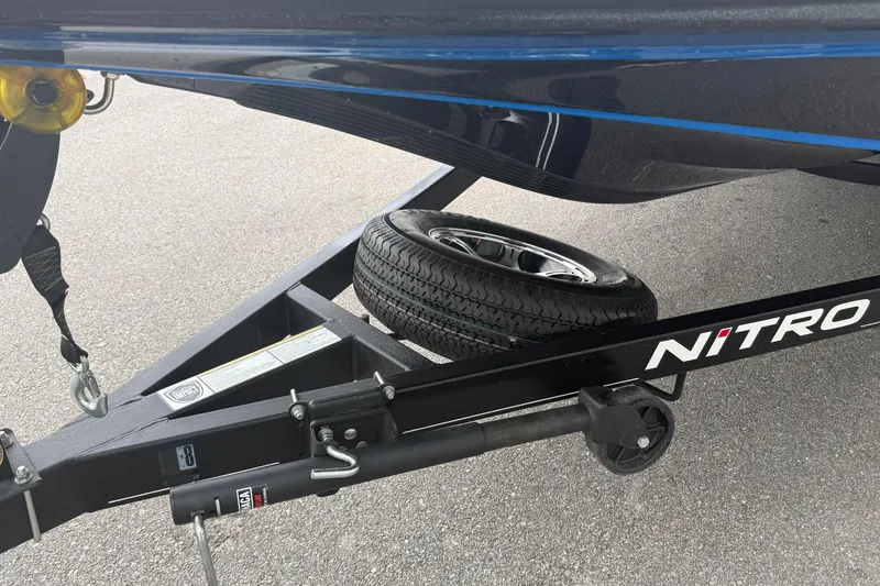 Slide: The Image of Trailer of a 2022 Nitro Z18 boat with spare tire on asphalt. - 10