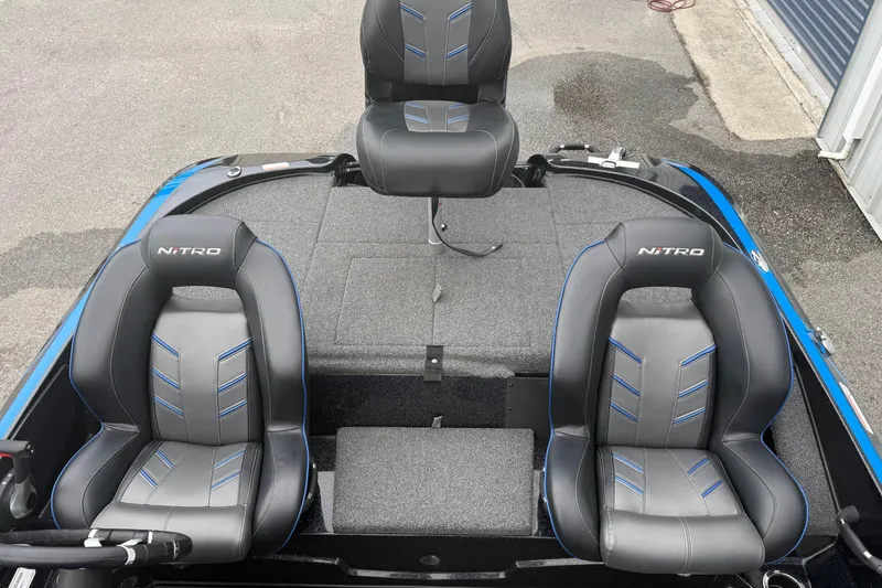 Slide: The Image of 2022 Nitro Z18 boat interior with three black and blue seats. - 13