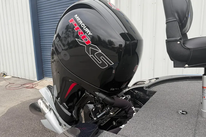 Slide: The Image of 2022 Nitro Z18 boat with Mercury Pro XS 150 engine, parked near a blue garage door. - 5