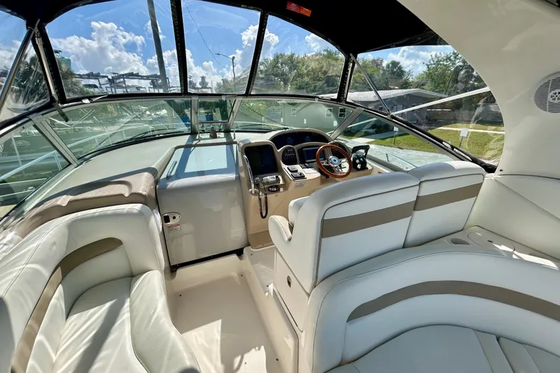 Slide: The Image of 2005 Sea Ray Sundancer 320 cockpit with luxurious seating and modern controls. - 13