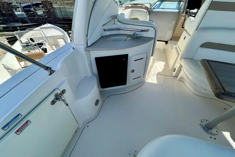 Slide: The Image of 2005 Sea Ray Sundancer 320 interior with sink, seating, and helm view. - 20
