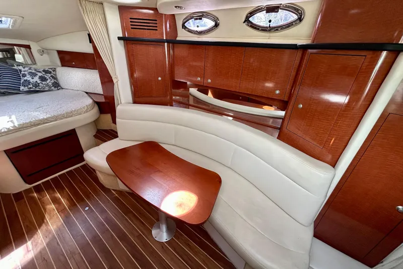 Slide: The Image of Luxurious interior of 2005 Sea Ray Sundancer 320 with wood accents and cozy seating. - 8