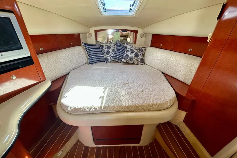 Slide: The Image of Luxurious cabin interior of 2005 Sea Ray Sundancer 320 with elegant bedding and wood finishes. - 9
