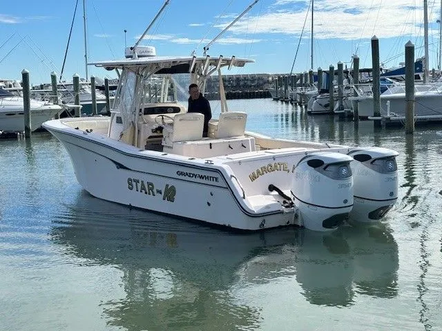 Slide: The Image of 2008 Grady-White Bimini 306 boat docked with twin outboard engines. - 1