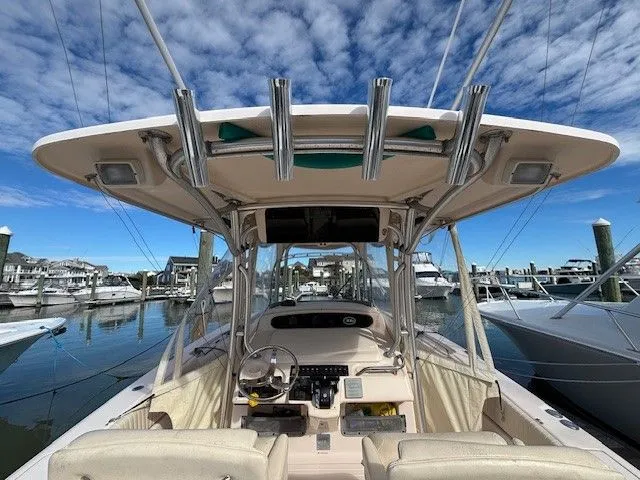 Slide: The Image of 2008 Grady-White Bimini 306 boat docked under clear sky. - 11