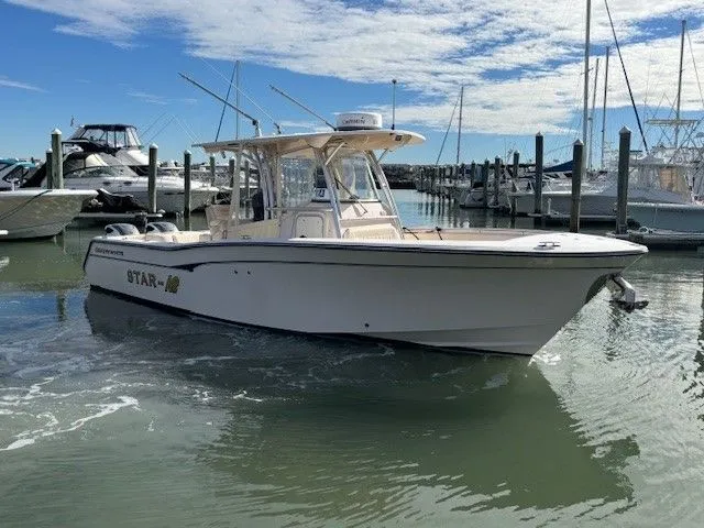 Slide: The Image of 2008 Grady-White Bimini 306 boat docked in sunny marina. - 2