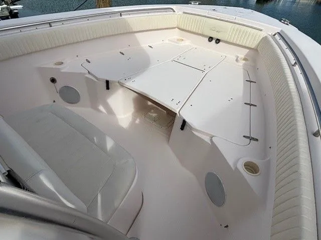 Slide: The Image of Interior of a 2008 Grady-White Bimini 306 boat, featuring white upholstery design. - 5