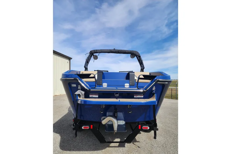 Slide: The Image of 2026 Heyday H22 boat, rear view, blue exterior, parked outdoors under a clear sky. - 2