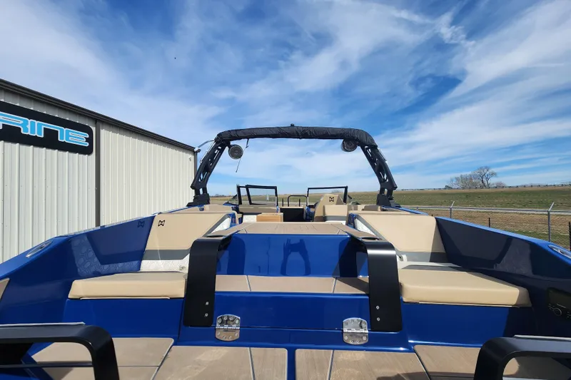 Slide: The Image of 2026 Heyday H22 boat with blue and beige interior, parked outdoors under a clear sky. - 5