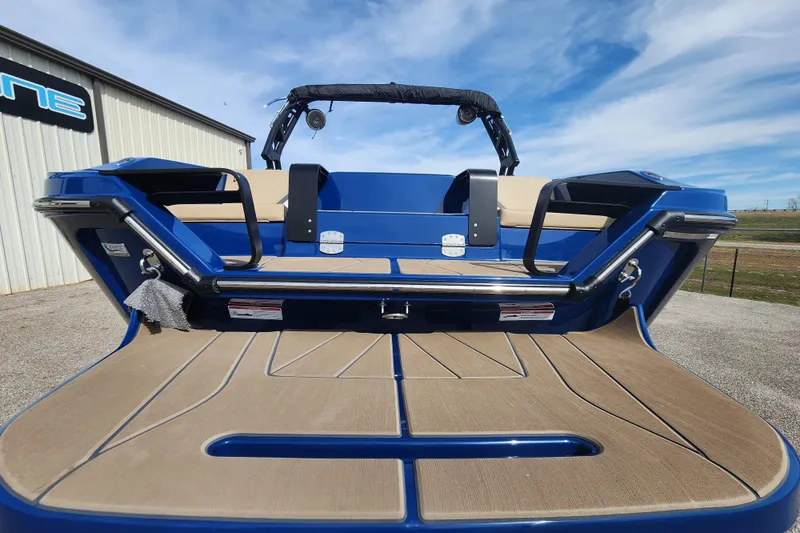 Slide: The Image of 2026 Heyday H22 boat with blue exterior and tan seating, docked outdoors. - 6