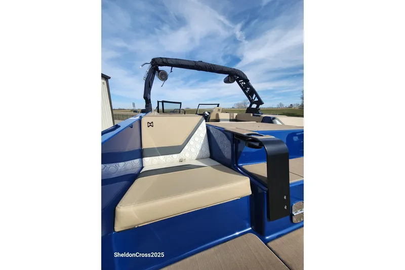 Slide: The Image of 2026 Heyday H22 boat interior with beige seating and blue accents under a clear sky. - 7