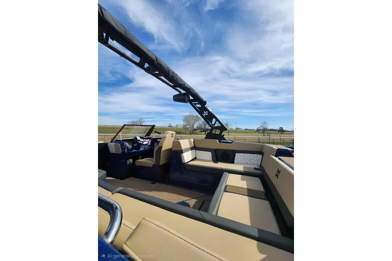 Slide: The Image of 2026 Heyday H22 boat interior with beige seating and blue accents under a clear sky. - 8
