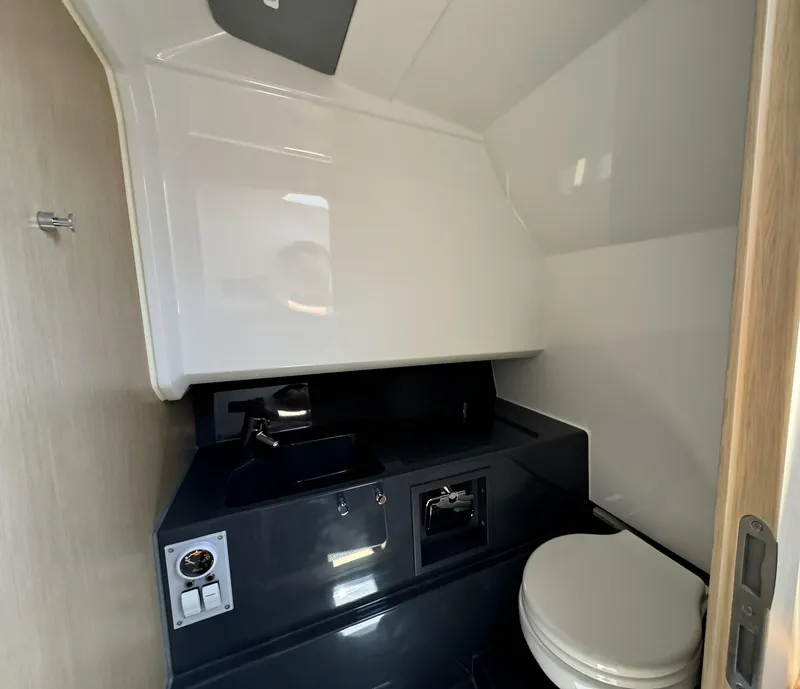 Slide: The Image of 2024 Windy SR28 CC boat bathroom with modern sink and toilet. - 16