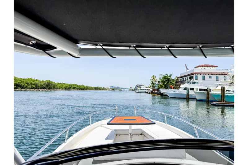 Slide: The Image of The image shows the foredeck of a 2024 Windy SR28 CC boat cruising on a calm waterway. - 12