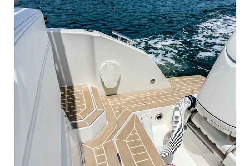 Slide: The Image of The image shows the stern of a 2024 Windy SR28 CC boat on the water. - 22