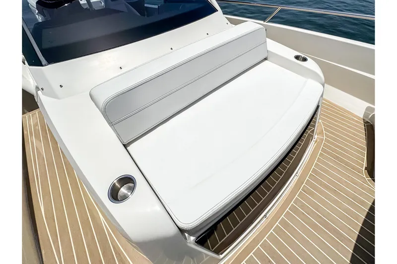 Slide: The Image of The image shows a white bench seat on a boat with a wooden deck. - 15