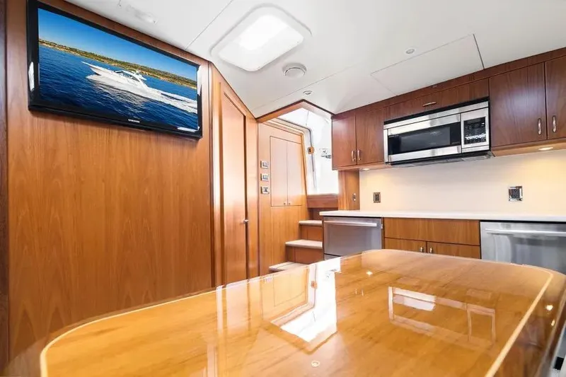 Slide: The Image of Luxurious interior of 2012 Cabo 44 Hardtop Express yacht with modern kitchen and TV. - 11