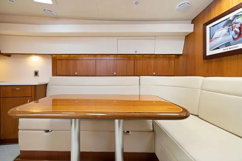 Slide: The Image of Luxurious interior of 2012 Cabo 44 Hardtop Express yacht with elegant wood and leather seating. - 12