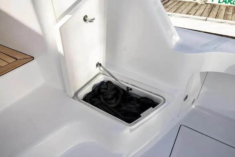 Slide: The Image of Storage compartment with rope on a 2012 Cabo 44 Hardtop Express boat deck. - 16
