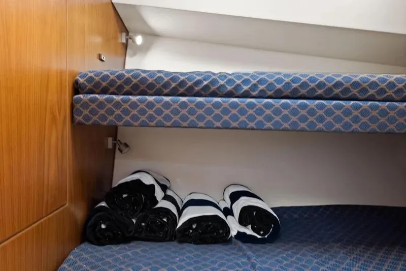Slide: The Image of Bunk beds with blue patterned cushions in a 2012 Cabo 44 Hardtop Express yacht. - 21