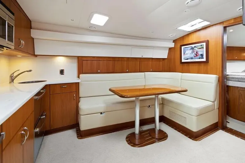 Slide: The Image of Interior of 2012 Cabo 44 Hardtop Express yacht with kitchen and dining area. - 3