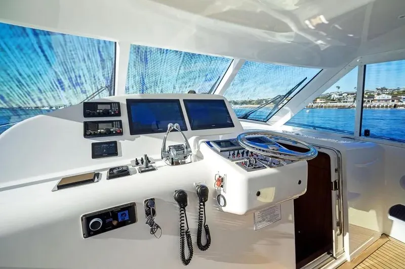 Slide: The Image of 2012 Cabo 44 Hardtop Express yacht helm with modern navigation equipment and ocean view. - 30