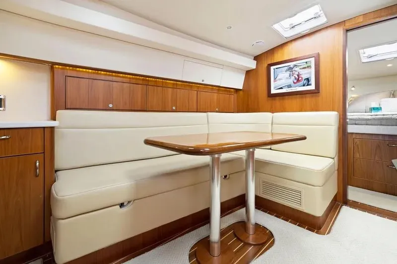 Slide: The Image of Luxurious interior of 2012 Cabo 44 Hardtop Express yacht with elegant seating and wooden finishes. - 5