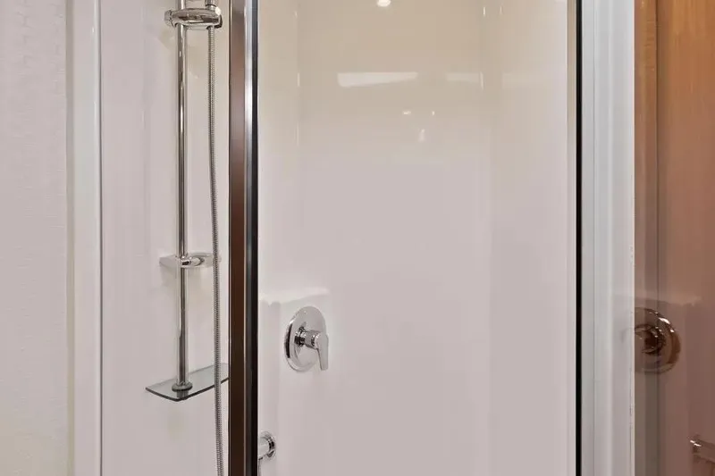 Slide: The Image of Shower area in 2012 Cabo 44 Hardtop Express yacht, featuring sleek chrome fixtures. - 9