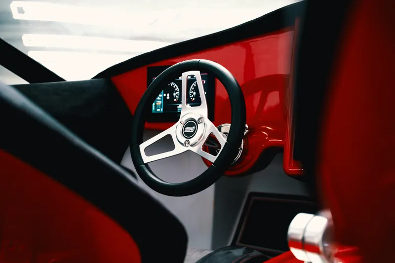 Slide: The Image of Steering wheel of 2025 Statement 360 CAT with modern dashboard design. - 17